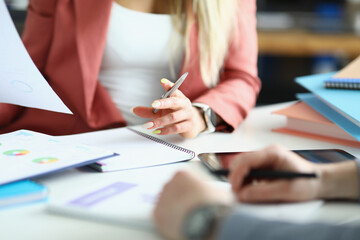 Coworkers discussing working moments and checking financial report