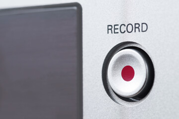 The inscription Record on a control panel above the button with a red dot.