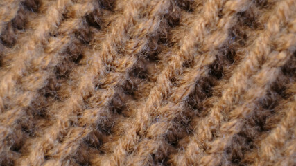 Textile abstract background. Clothing industry concept. Wavy clean material. Fibers of knitted clothes brown white threads. Knitted fabric threads macro