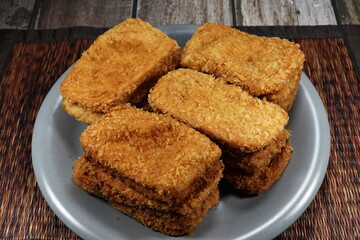 Pile of deep fried crispy fish fillet serving on the plate. Famous appetizer menu in party.