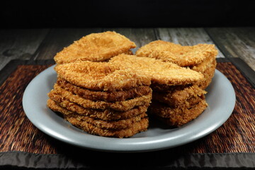 Pile of deep fried crispy fish fillet serving on the plate. Famous appetizer menu in party.