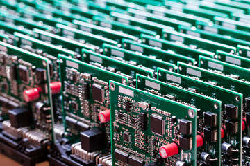 Closeup of Line of Ready Automotive Printed Circuit Boards with Surface Mounted Components.