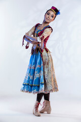 Positive Asian Japanese Female Ballet Dancer In Stage Outfit Costume Posing in Dance Pose With Folded Hands and Patterns Over White Background.