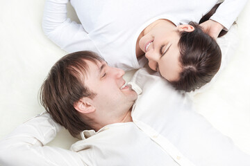Caucasian Loving Happy Couple Posing With Heads Turned to Each Other Closely Together Over White Background.
