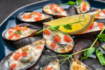 Baked mussels with cheese, salmon, lemon and herbs