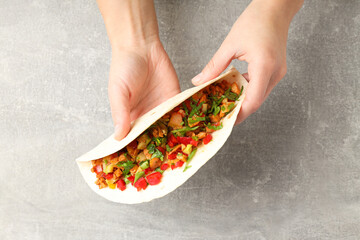 Concept of tasty food with taco on grey textured background