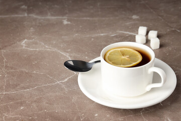 Concept of hot drink with tea on beige textured background