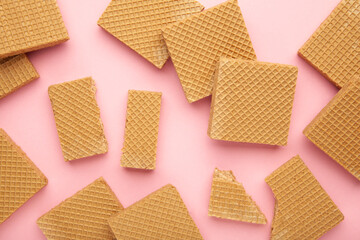 Square chocolate wafer biscuits on pink background.