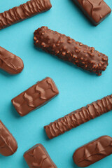 Mix of chocolate bars on blue background. Top view.