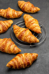 Fresh croissants on black background.
