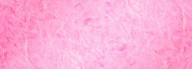 background of light pink, textured, handmade mulberry paper.