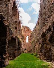 Ruined medieval citadel long hallway with brick walls