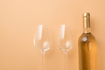 Top view photo of saint valentine's day decorations bottle of white wine and two wineglasses on isolated pastel beige background with copyspace