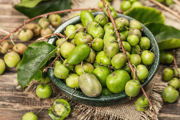 Harvest of ripe Actinidia arguta kiwi in a ceramic bowl