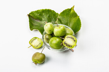 Ripe Actinidia arguta or kiwi isolated on white background