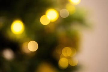 Abstract bokeh lights with soft light background. Festive abstract christmas texture, golden bokeh particles and highlights on dark background.