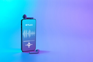 Music banner. Mobile smartphone screen with music application, sound headphones. Audio voice with radio beats on neon gradient background. Broadcast media music banner with copy space.