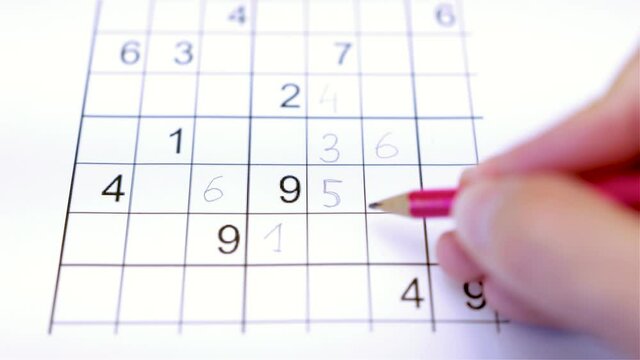 Playing and solving sudoku puzzle game with a pencil, mathematics mental exercise