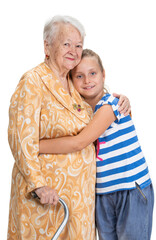 Happy smiling grandmother with granddaughter hugging in studio