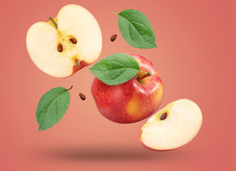 Red apple with leaves falling in the air isolated on red background, Red Envy apple on red background With clipping path.