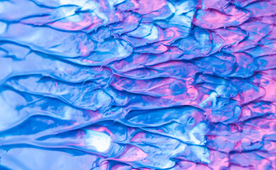 Fototapeta na wymiar Beautiful abstract background with spots of blue, pink, green, yellow and purple paint. Oil paint, flowing down the canvas, shimmers with galagrophic paints with neon illumination.