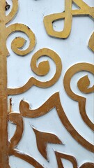 Background texture of carvings on white and gold walls in the Cicalengka area, Indonesia