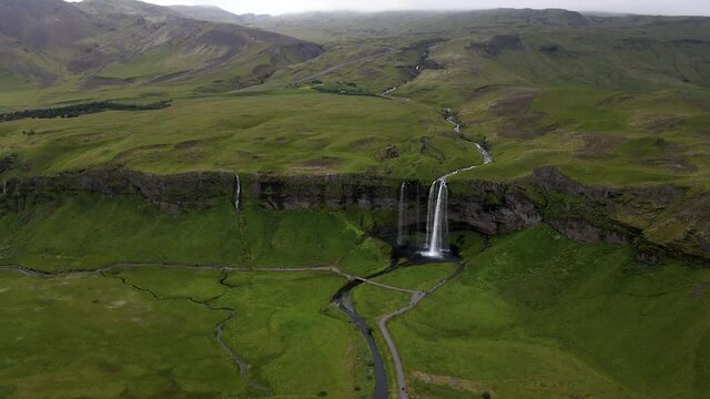 Cinematic aerial footage of the Beautiful Seljalandsfoss and Gljufrabui waterfalls in Iceland on summer