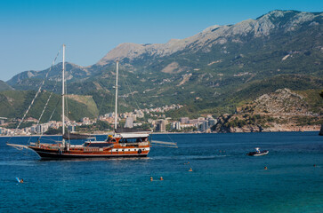 Fototapeta na wymiar pleasure ship boat sailing in Adriatic Sea near town Budva, Montenegro, Europe..