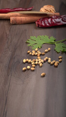 Dry coriander seeds with small bamboo spoon and green fresh bunch coriander leaves,famous spices ingredients in asia's kitchen.