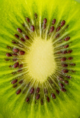 Kiwi closeup as background. Ripe kiwi fruit in the cut. Kiwi seed texture.