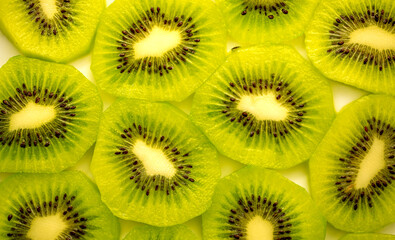 Kiwi closeup as background. Ripe kiwi fruit in the cut. Kiwi seed texture.