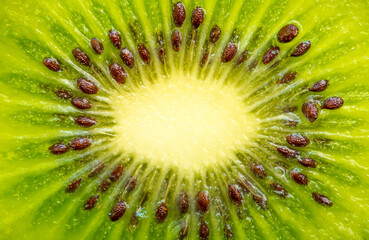 Kiwi closeup as background. Ripe kiwi fruit in the cut. Kiwi seed texture.