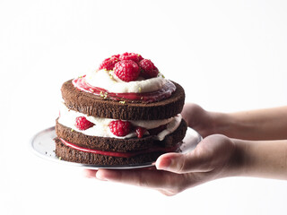 hand holding chocolate raspberry layer cake