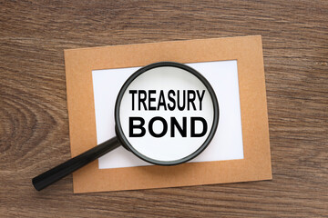 Treasury bonds. Trading concept. Magnifying glass on a wooden table