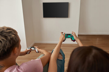 Partial image of lesbian girls playing video game © Svitlana