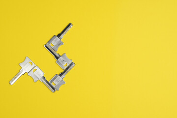 Set of door keys on a colored background, top view, flat lay. Conceptual composition.