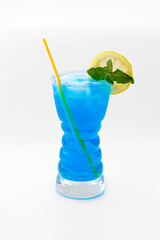 A drink - a glass with a blue cocktail - a tall transparent cup, straws, a circle of lemon, mint leaves. Isolated