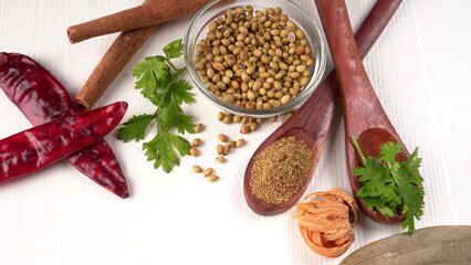 Dry coriander seeds with small bamboo spoon and green fresh bunch coriander leaves,famous spices ingredients in asia's kitchen.