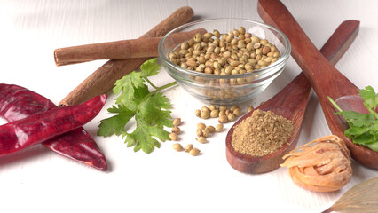 Dry coriander seeds with small bamboo spoon and green fresh bunch coriander leaves,famous spices ingredients in asia's kitchen.