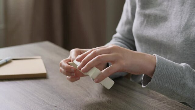 medicine, quarantine and pandemic concept - hands of woman unpacking coronavirus test kit at home