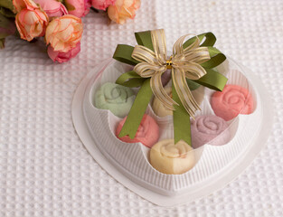 Flower shape colorful cookies in heart shape gift box with beautiful ribbon
