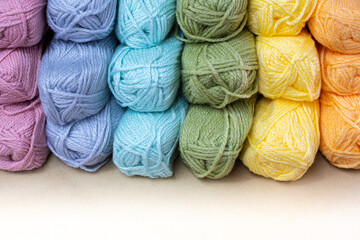 Close Up of yarn balls. Rainbow colors. Yarn for knitting. Skeins of yarn. Knitting needles,...