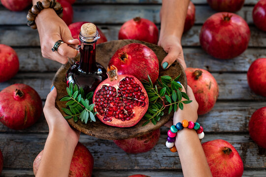 Pomegranate syrup named nar ekşisi with pomegranates on the serving platter. 