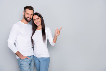 Photo of cute millennial couple indicate promo wear white shirt isolated on grey color background