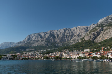 Landscape of Makarska town in the Adriatic sea coast under the Biokovo mountain in Croatia, during summer sunny day