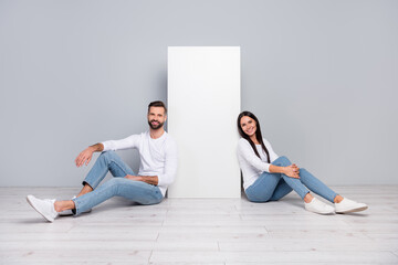 Photo of pretty lady guy wear white shirts sitting floor white wall empty space isolated concrete grey wall background