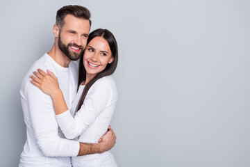 Photo of charming dreamy guy lady dressed white shirts looking empty space hugging isolated grey...