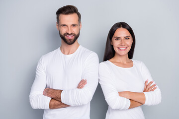 Portrait of attractive cheerful couple folded arms trust good support isolated over grey pastel color background