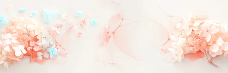 Fototapeten Creative image of pastel blue and pink Hydrangea flowers on artistic ink background. Top view with copy space  © tomertu