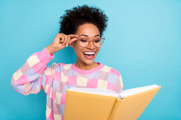 Portrait of attractive trendy cheery ecstatic wavy-haired girl reading interesting book isolated...